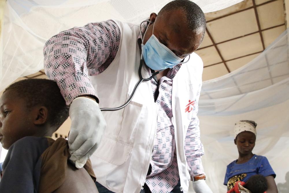 MSF emergency team doctor, examines a child 